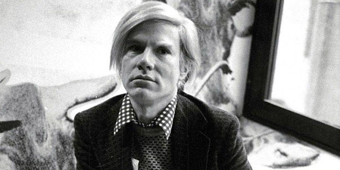 Black-and-white photo of Andy Warhol in the 1960s.