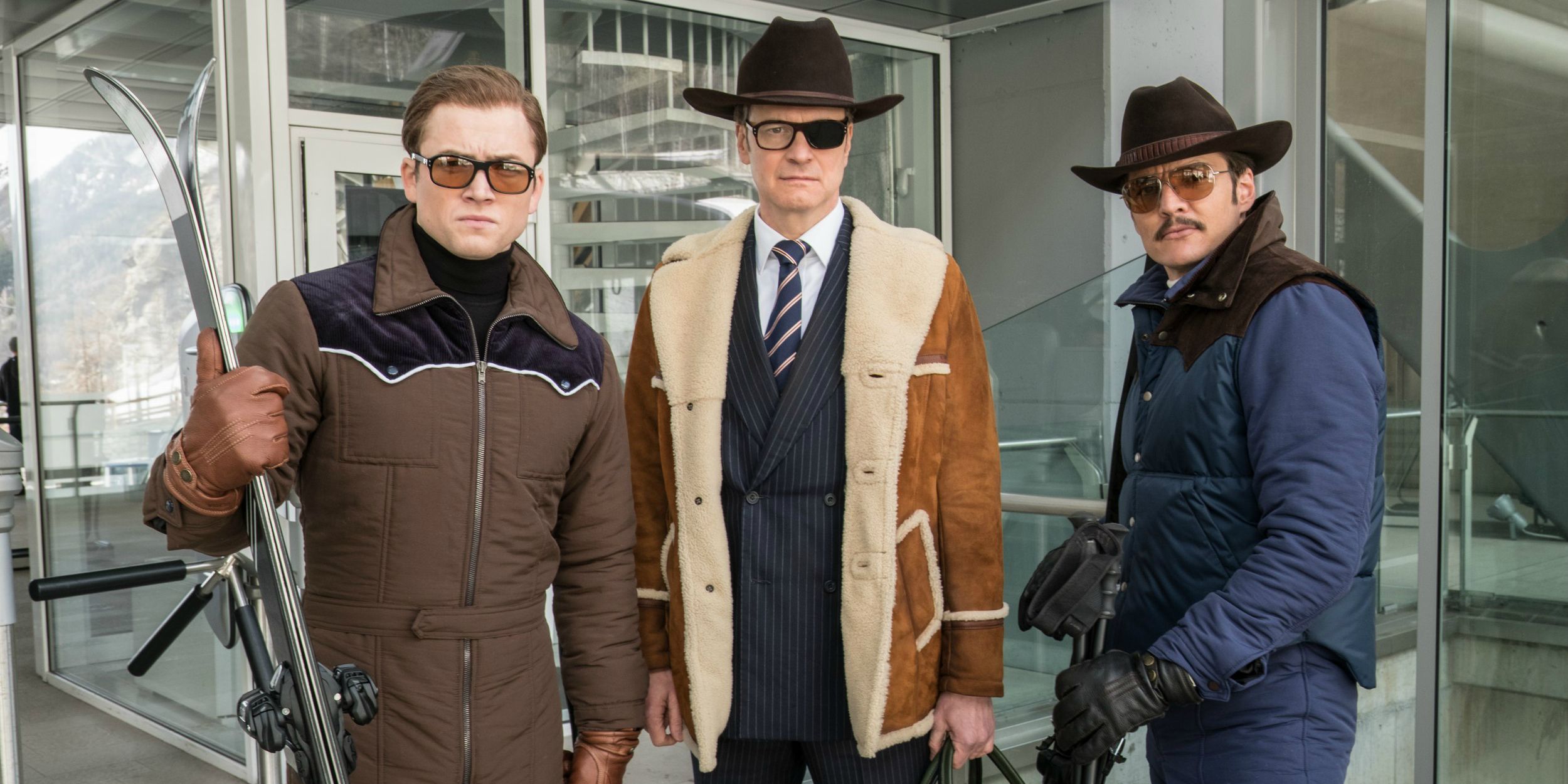 Eggsy, Harry, and Whiskey looking at the front in Kingsman 2 wearing snow gear