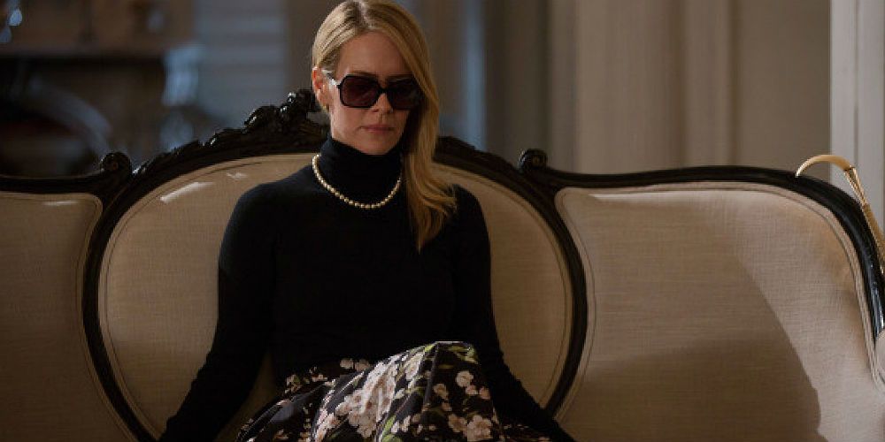 Cordelia sitting on a sofa in AHS-Coven