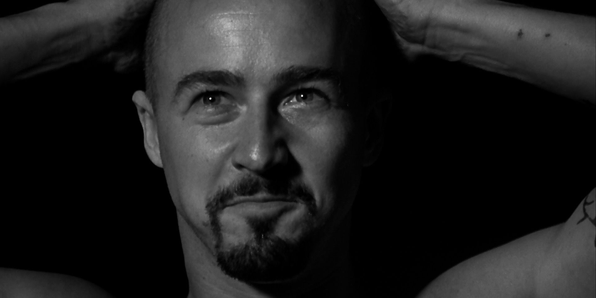 Edward Norton with his hands on his head in American History X