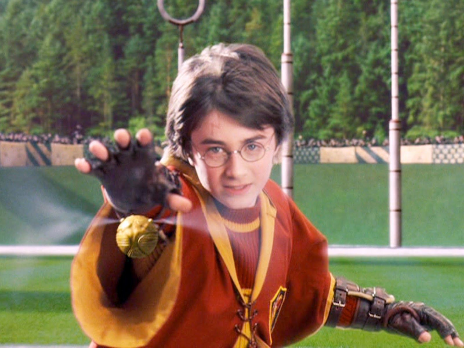 Harry Potter Catches The Golden Snitch in Harry Potter and the Sorcerers Stone