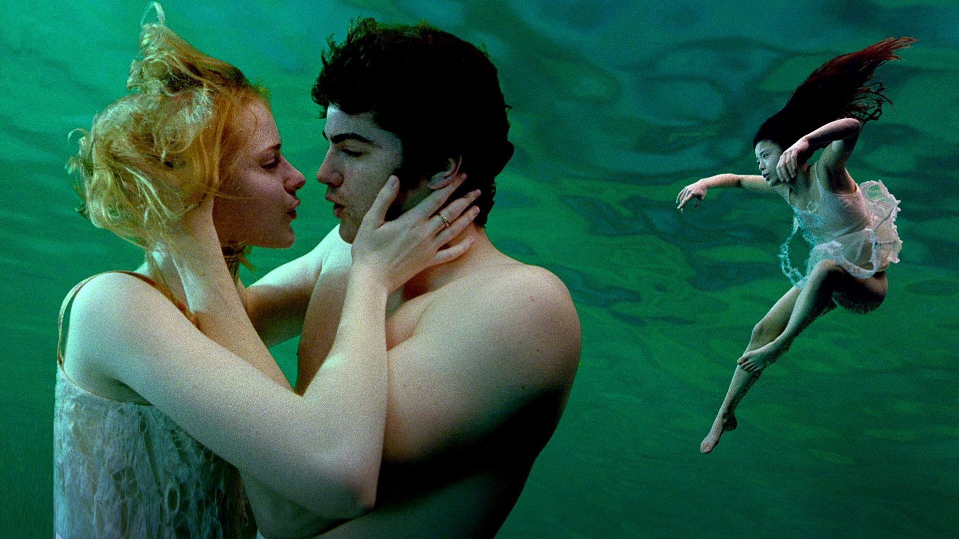 Jim Sturgess as Jude Evan Rachel Wood as Lucy and TV Carpio as Prudence in Across the Universe, embracing each other underwater
