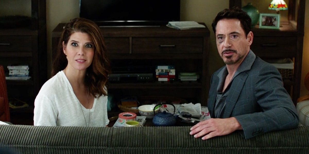 Marisa Tomei and Robert Downey Jr sitting on a couch in Captain America Civil War