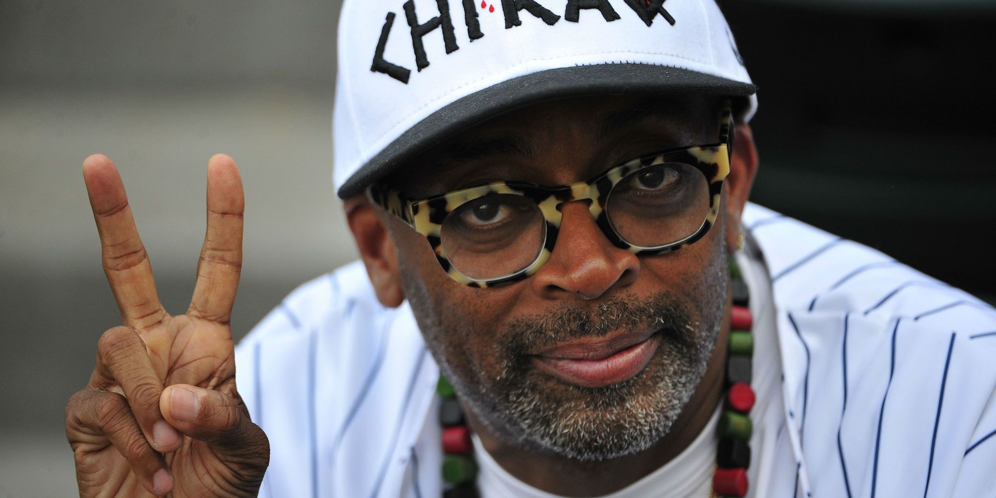 Spike Lee posing for camera flashing peace sign