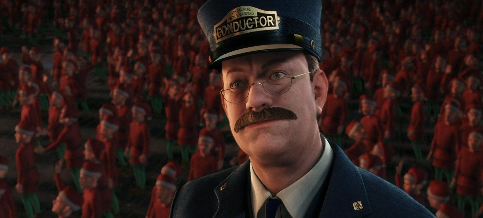Tom Hanks as the conductor smiling in front of elves in The Polar Express