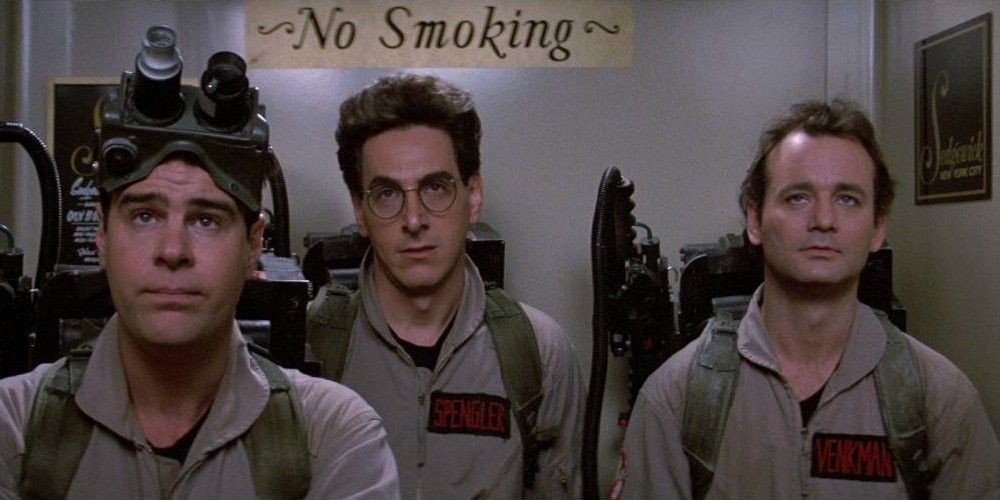 The Ghostbusters riding in an elevator