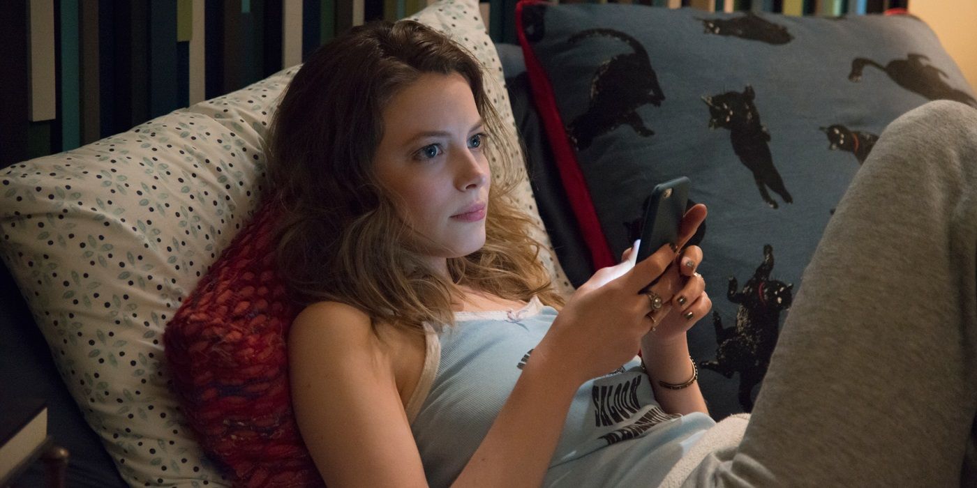 Mickey lying down with her phone in Love