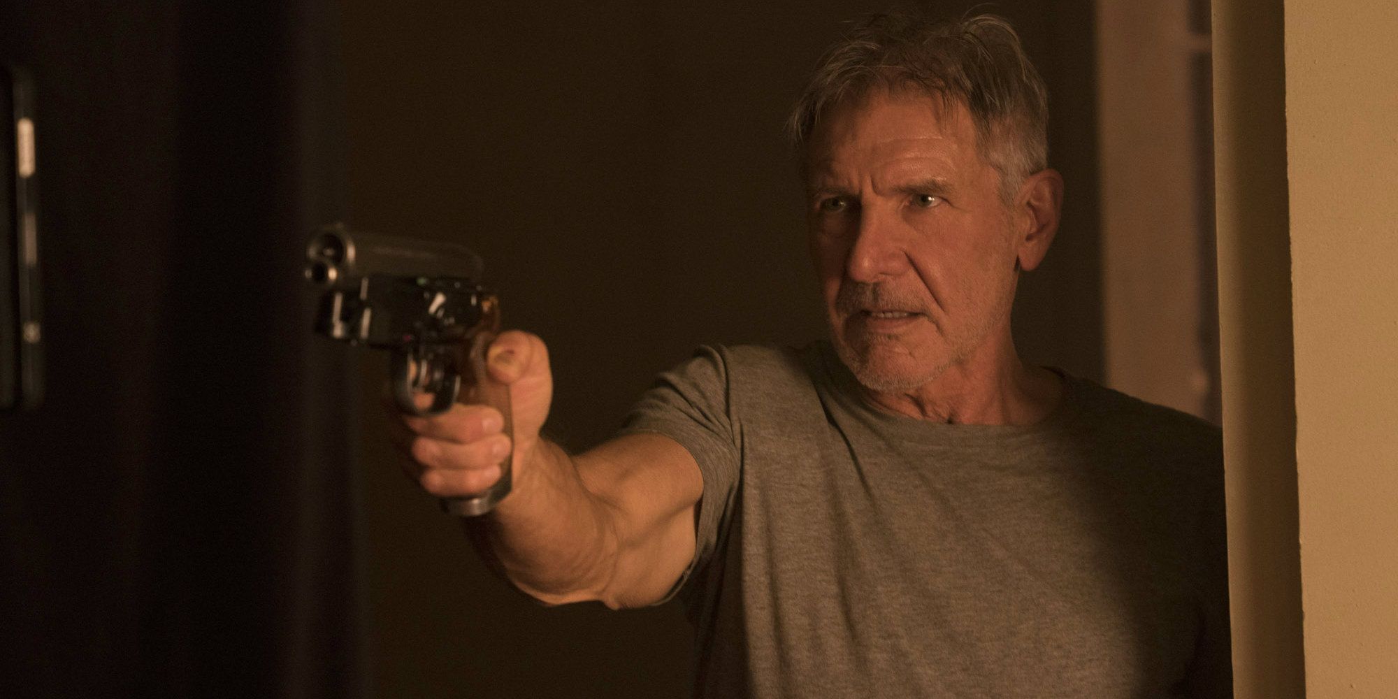 Rick Deckard holding a gun in Blade Runner 2049