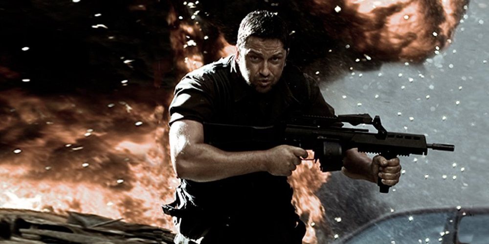 Gerard Butler as Kable in Gamer, running with a gun against an exploding background