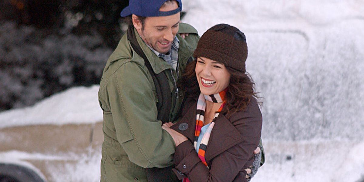 Luke holding onto Lorelai on a skating winter outside during the winter on Gilmore Girls