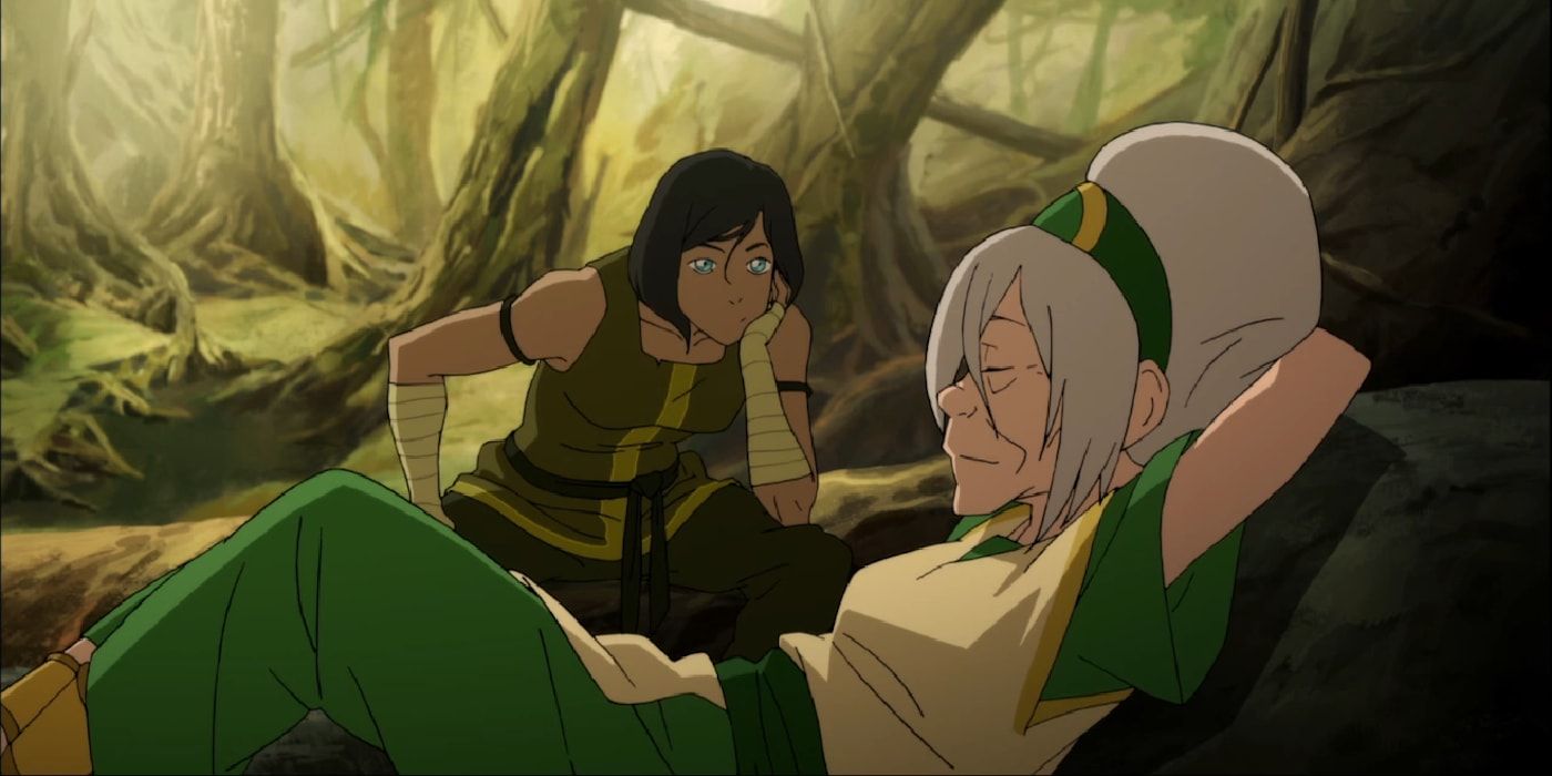 Toph relaxes on a tree trunk as Korra looks on disapprovingly in The Legend of Korra.