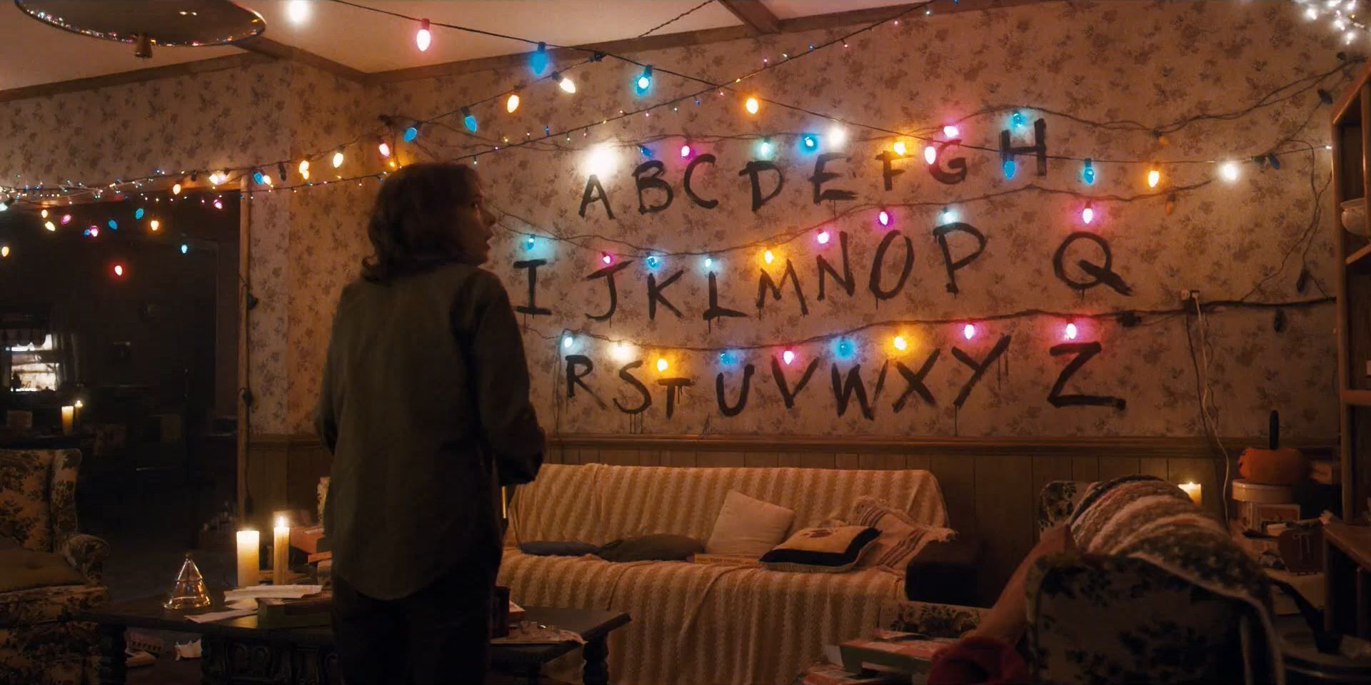 Joyce stares at lights on the wall in Stranger Things