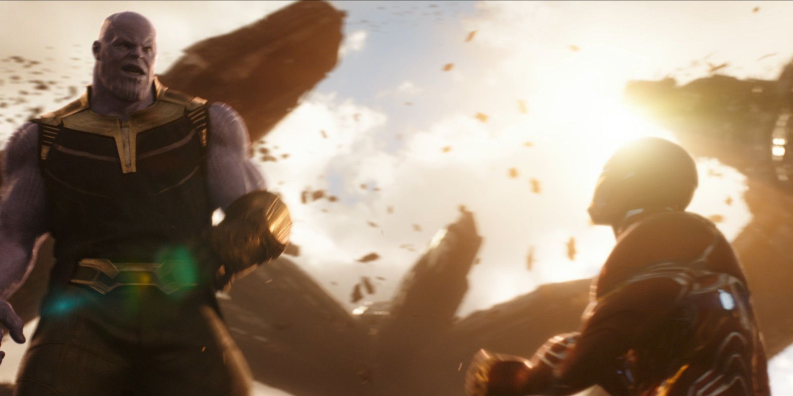 Thanos stands while Iron Man lays on the ground in Infinity War