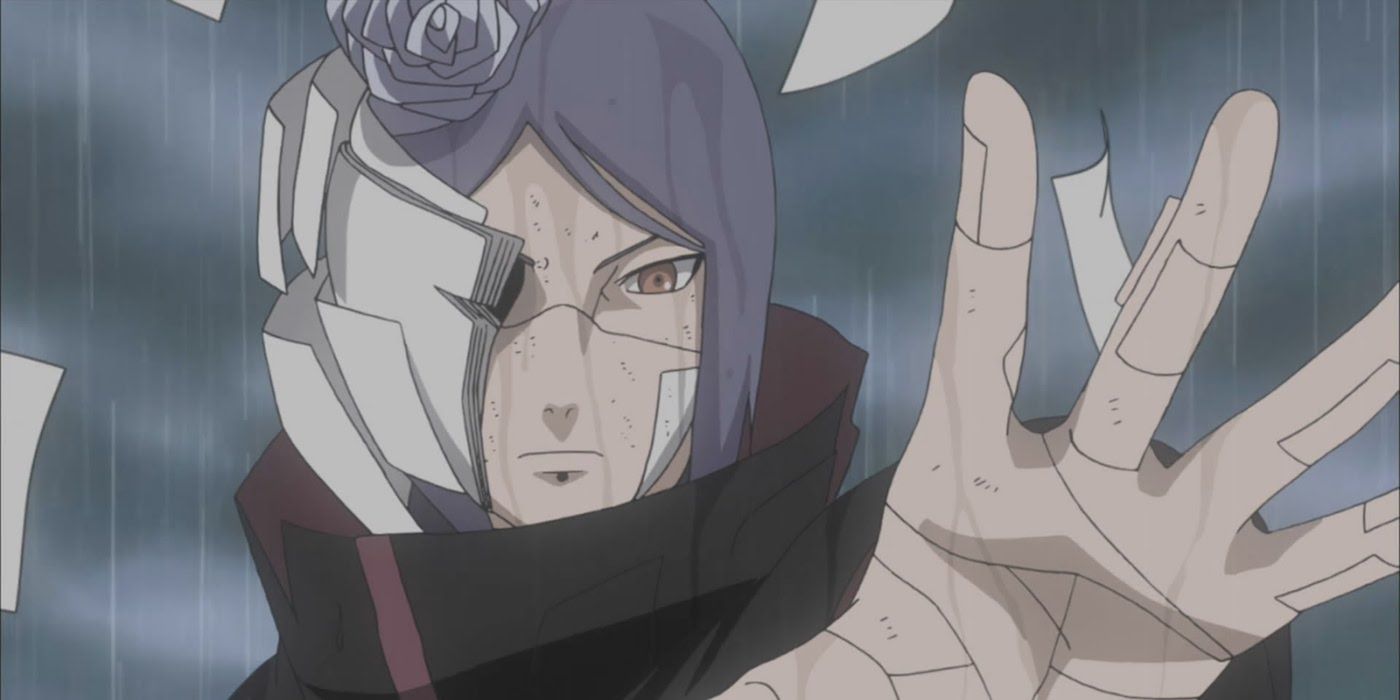 Konan with her hand outstretched and sheets of paper flying off of her