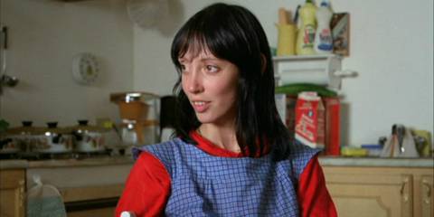 Shelley Duvall as Wendy Torrance smiling in a red and blue outfit in The Shining