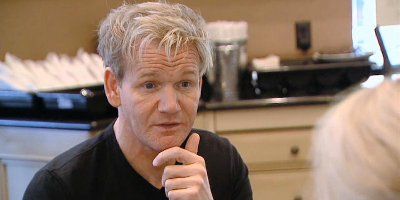 Gordon Ramsay on Kitchen Nightmares sitting across from an owner, talking to them