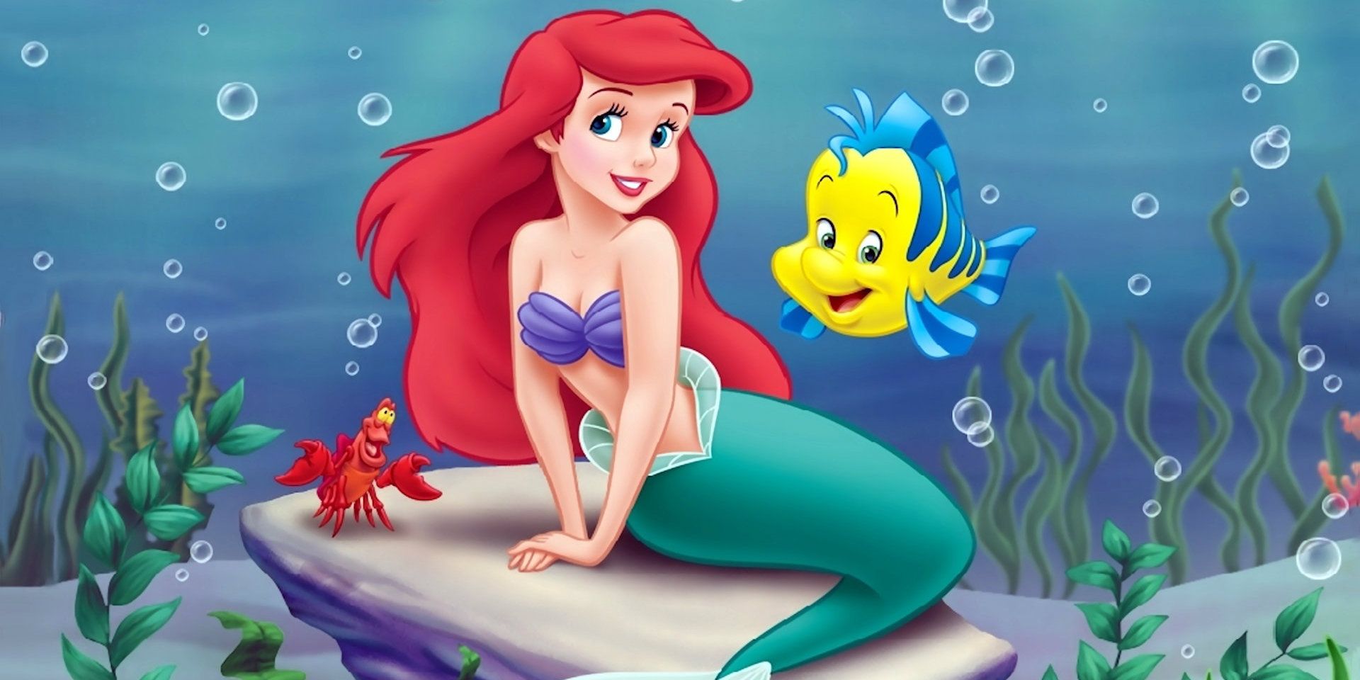 Ariel sits on a rock under the sea in The Little Mermaid