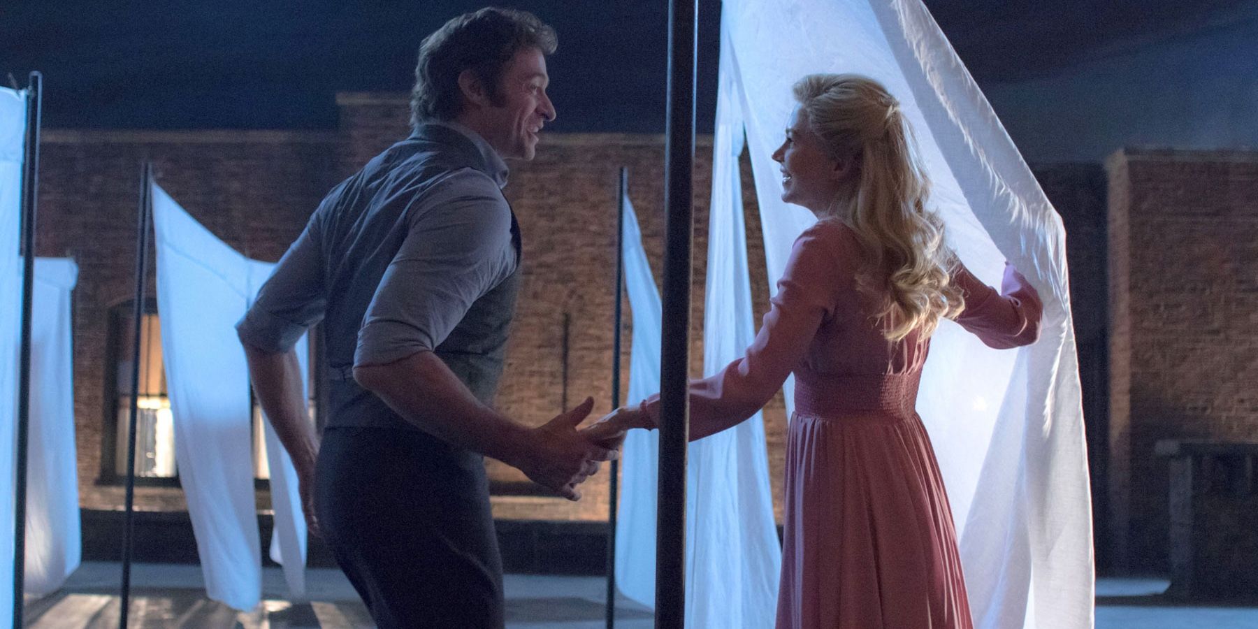 Hugh Jackman and Michelle Williams on a rooftop in The Greatest Showman