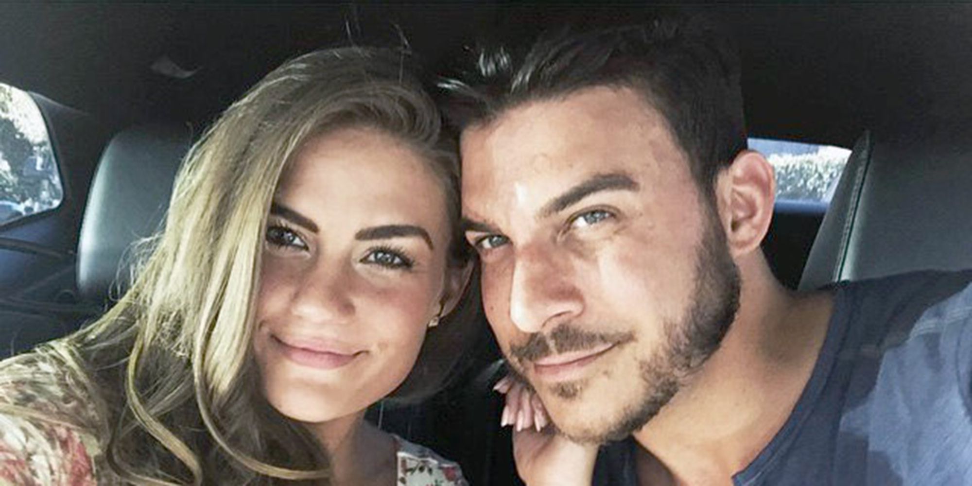 Jax Taylor and Brittany Cartwright from Vanderpump Rules smiling in their vehicle.