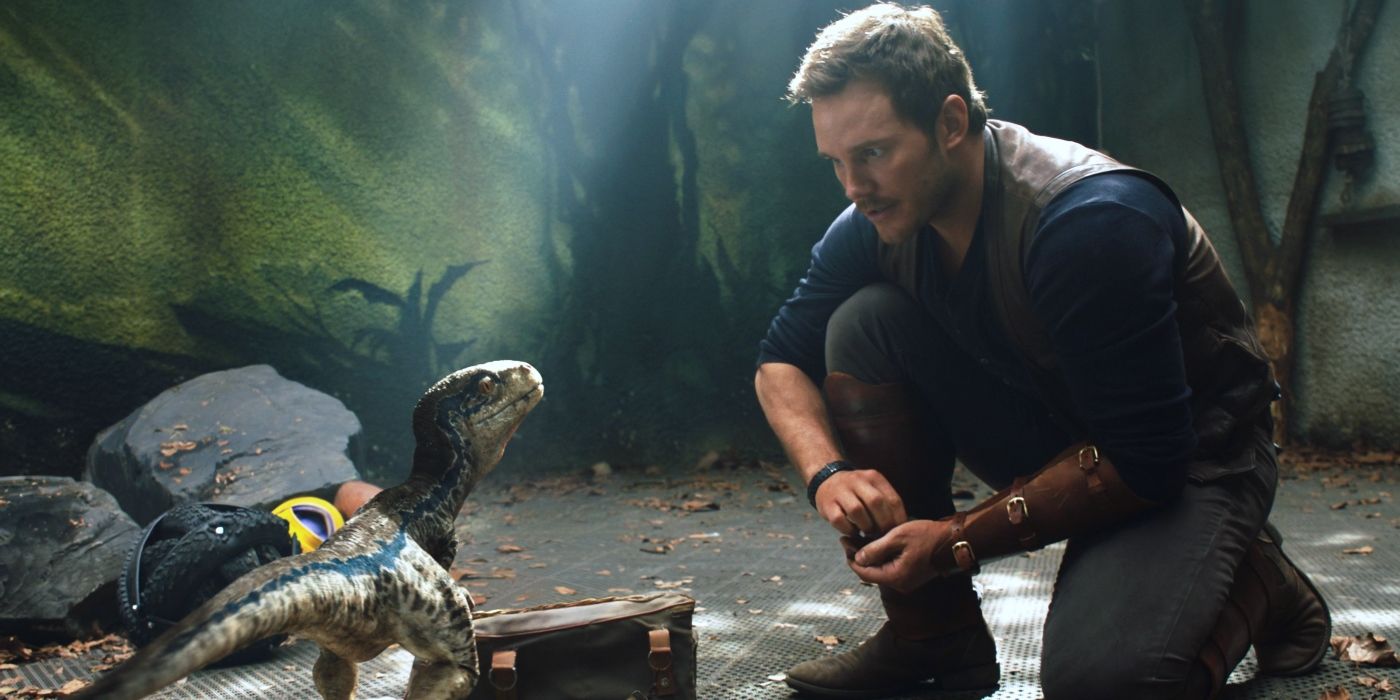 Chris Pratt and a baby raptor in Jurassic World: Fallen Kingdom