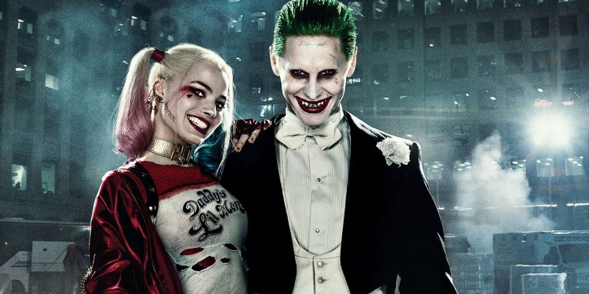 Joker and Harley Quinn grin in to the camera