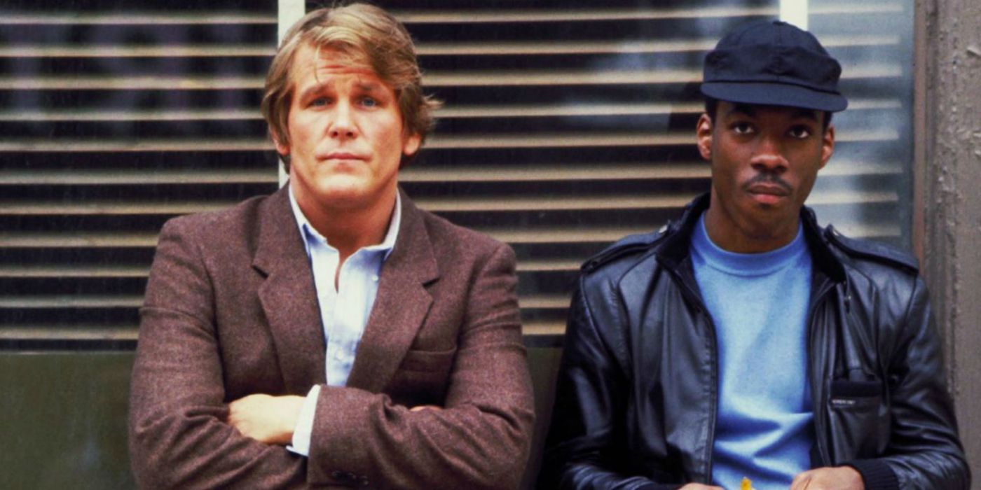 Nick Nolte and Eddie Murphy leaning on a wall in 48 Hrs.