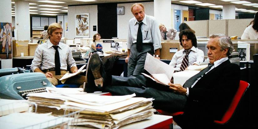 Woodward and Bernstein sit at their desks with their publishers in All the President's Men