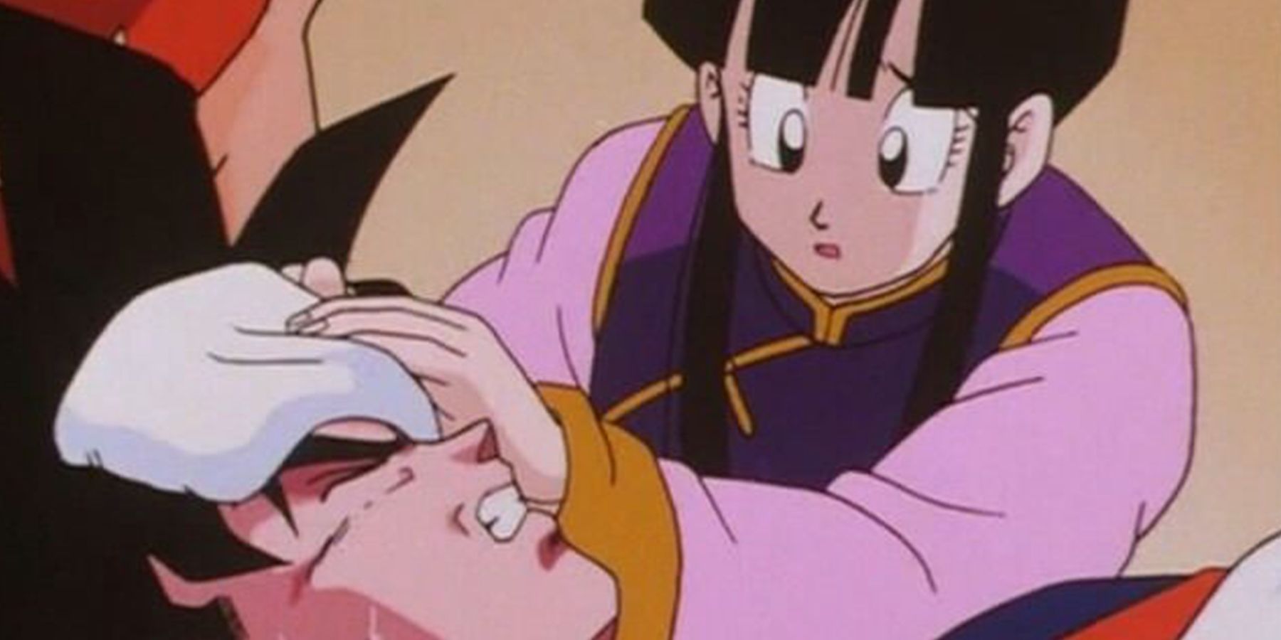 A concerned Chi-Chi takes care of Goku while he's sick in Dragon Ball.