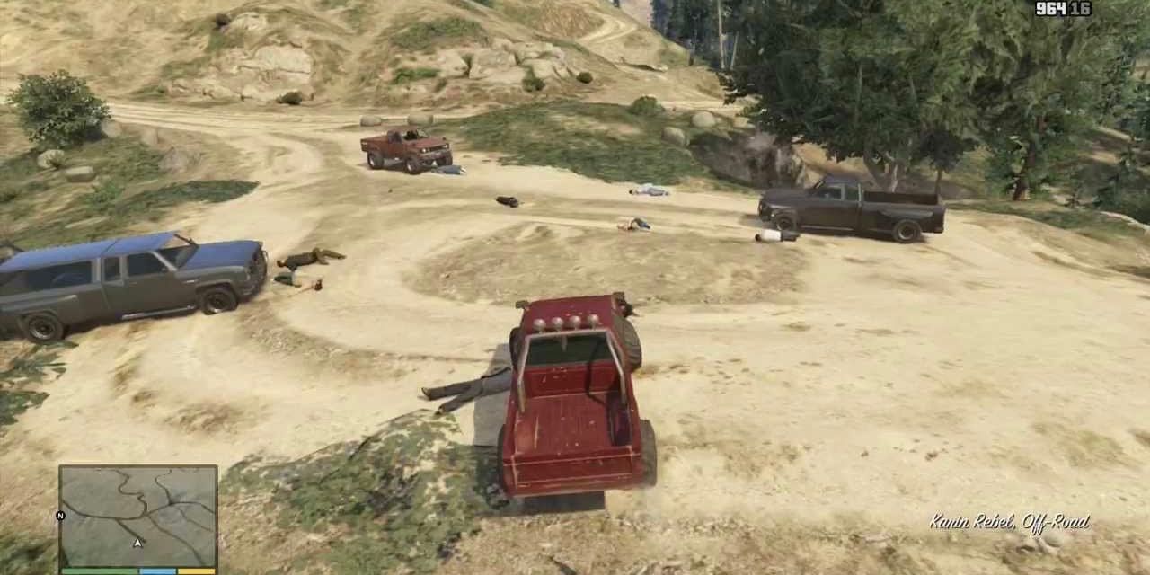 Several trucks are parked on a hill with dead bodies scattered around in GTA V