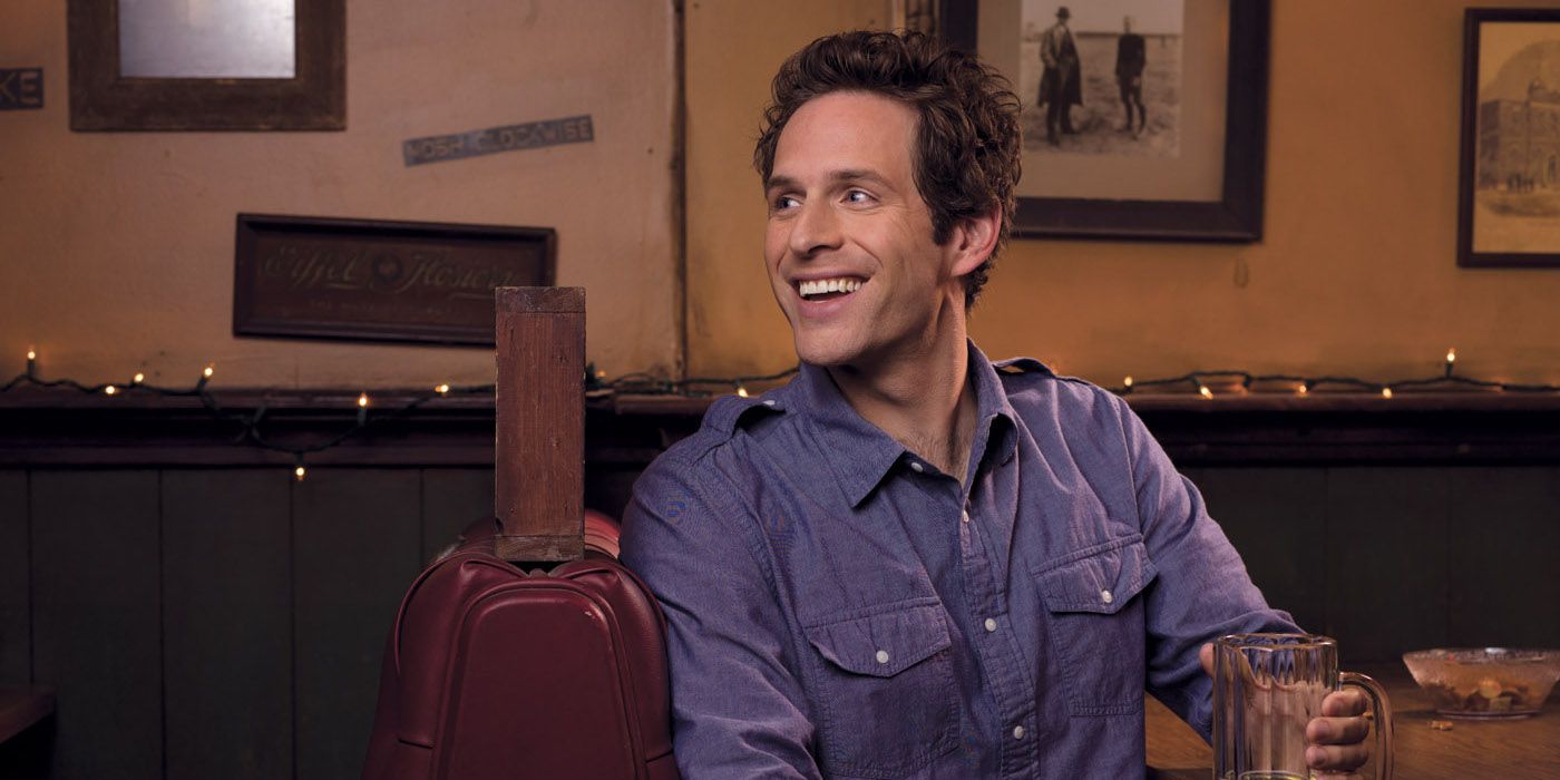 Dennis at the bar smiling in It's Always Sunny in Philadelphia