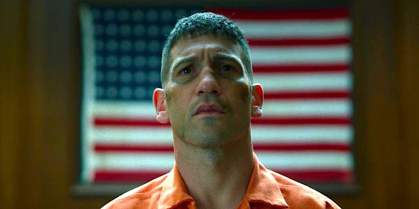 Punisher stands in front of a US flag
