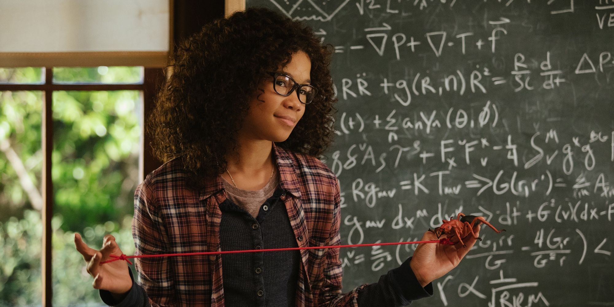 Storm Reid confidently stands in front of a chalkboard