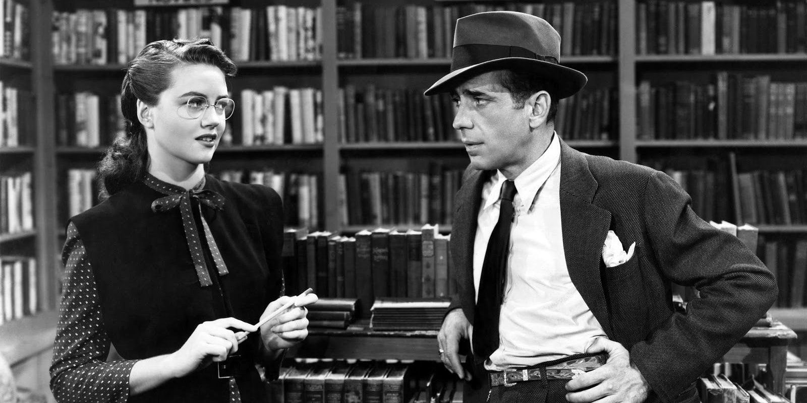 Dorothy Malone and Humphrey Bogart standing and looking at each other inside a library in The Big Sleep