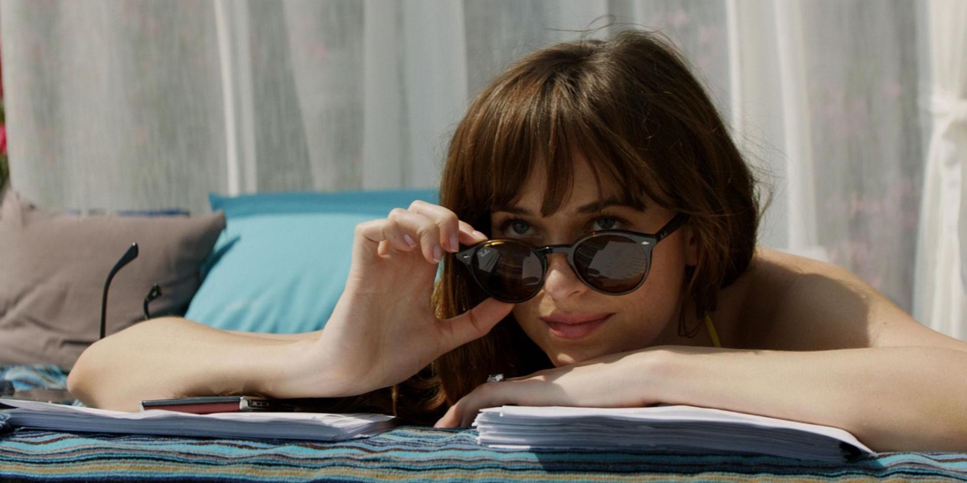 Anastasia Steele looks on in shades while laying down in Fifty Shades Freed