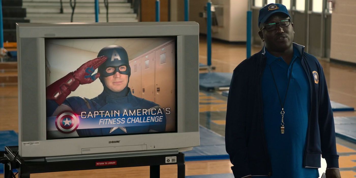 Coach Wilson stands next to a TV in the gym in Spider-Man: Homecoming.