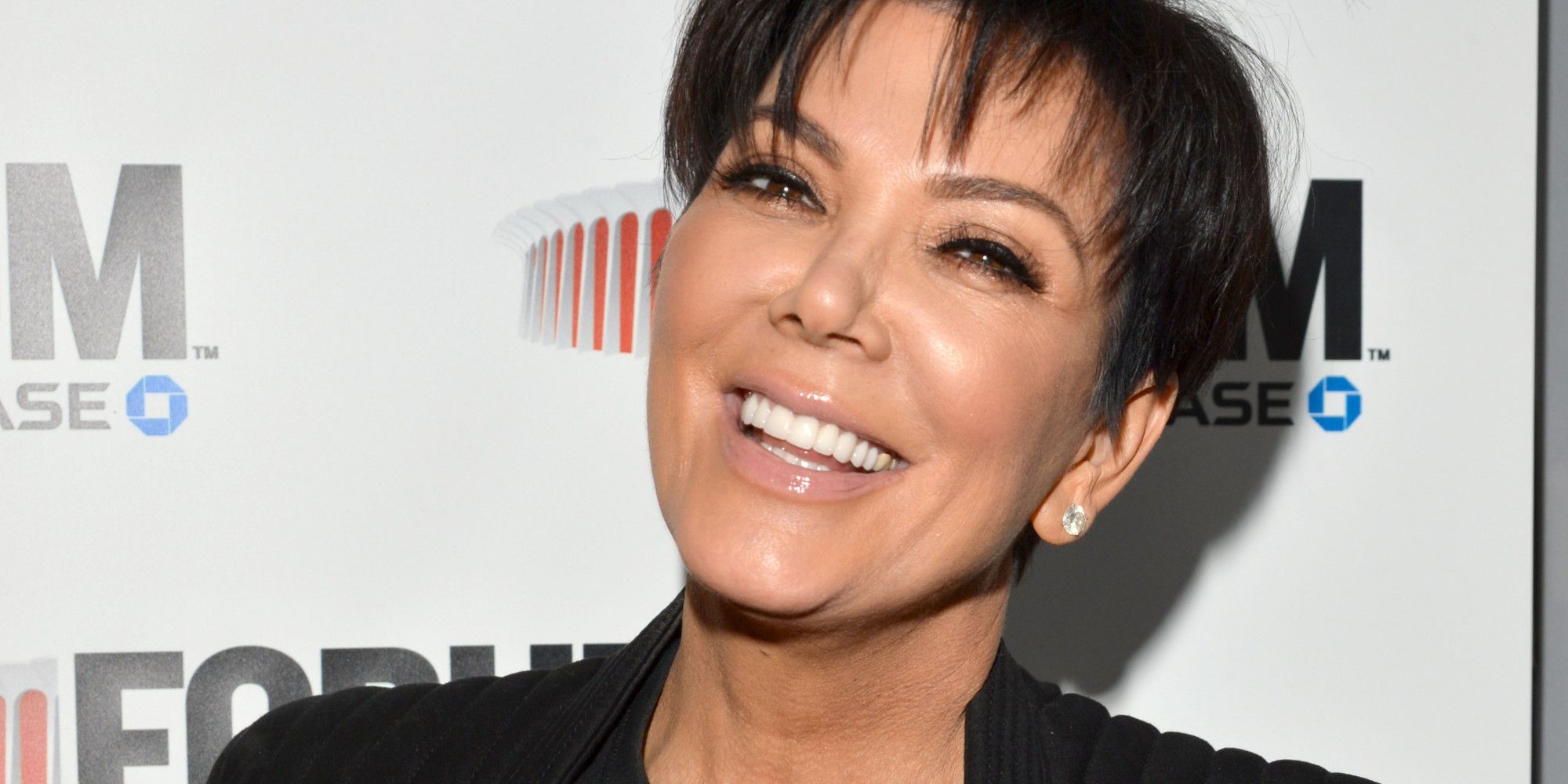 Kris Jenner smiling big.