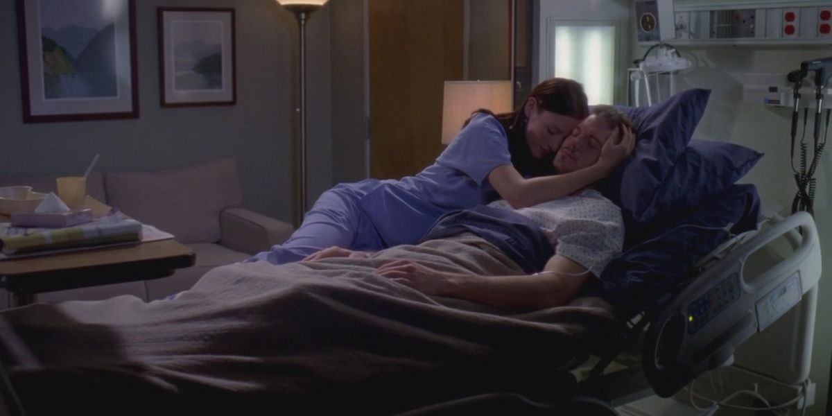 Lexie and Mark lying in a bed together in Grey's Anatomy