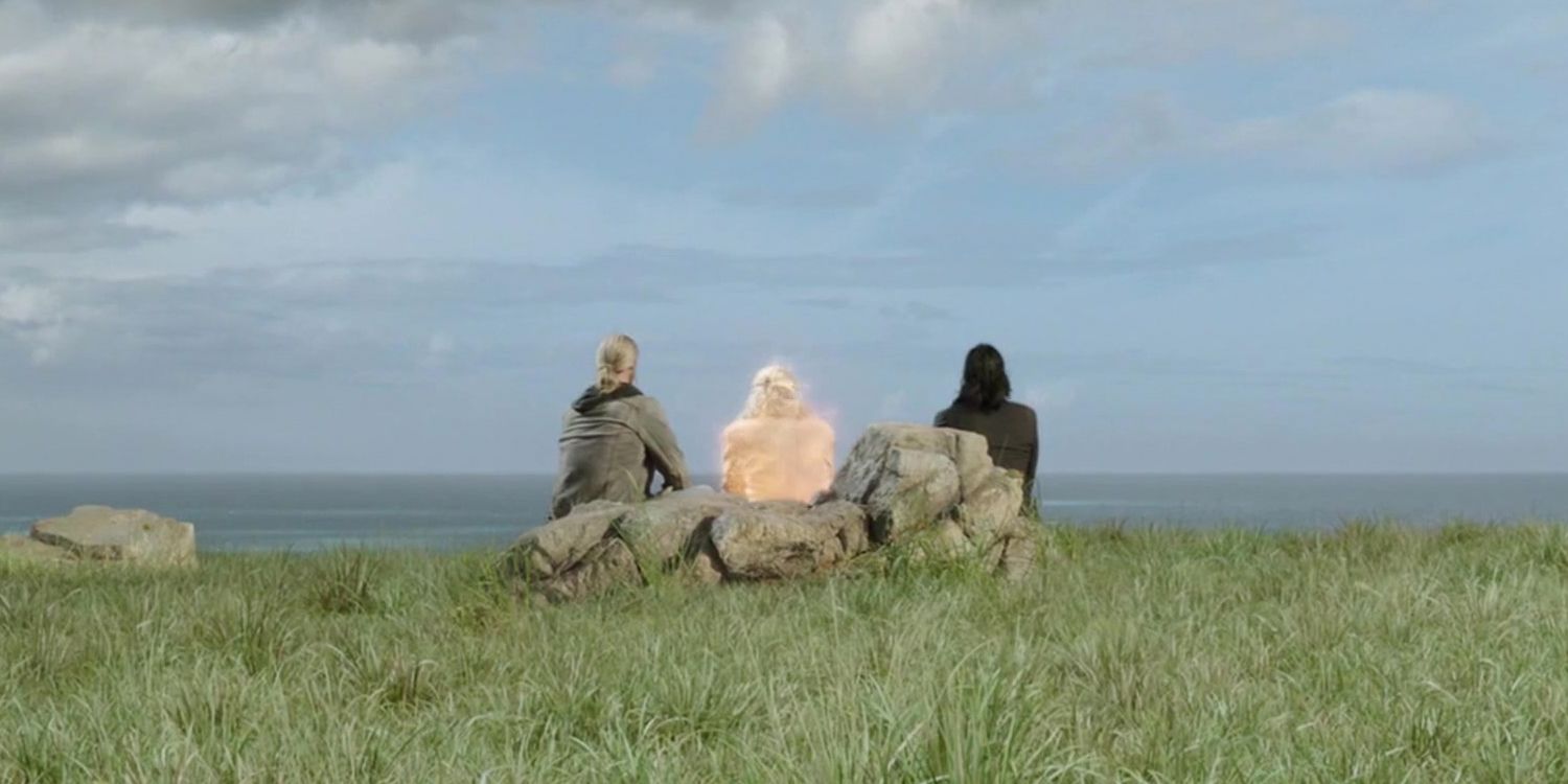 Odin sits with Thor and Loki in a green field in Thor Ragnarok