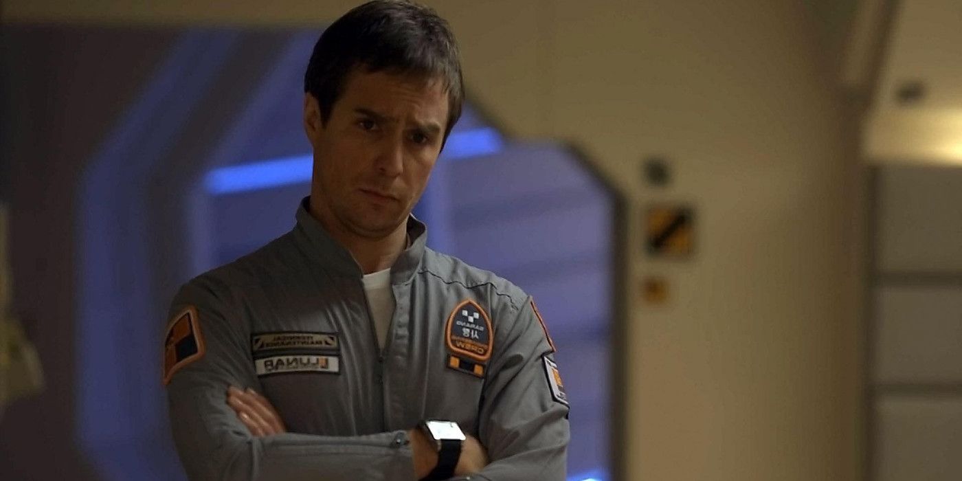 Sam Rockwell standing with his arms crossed in Moon.