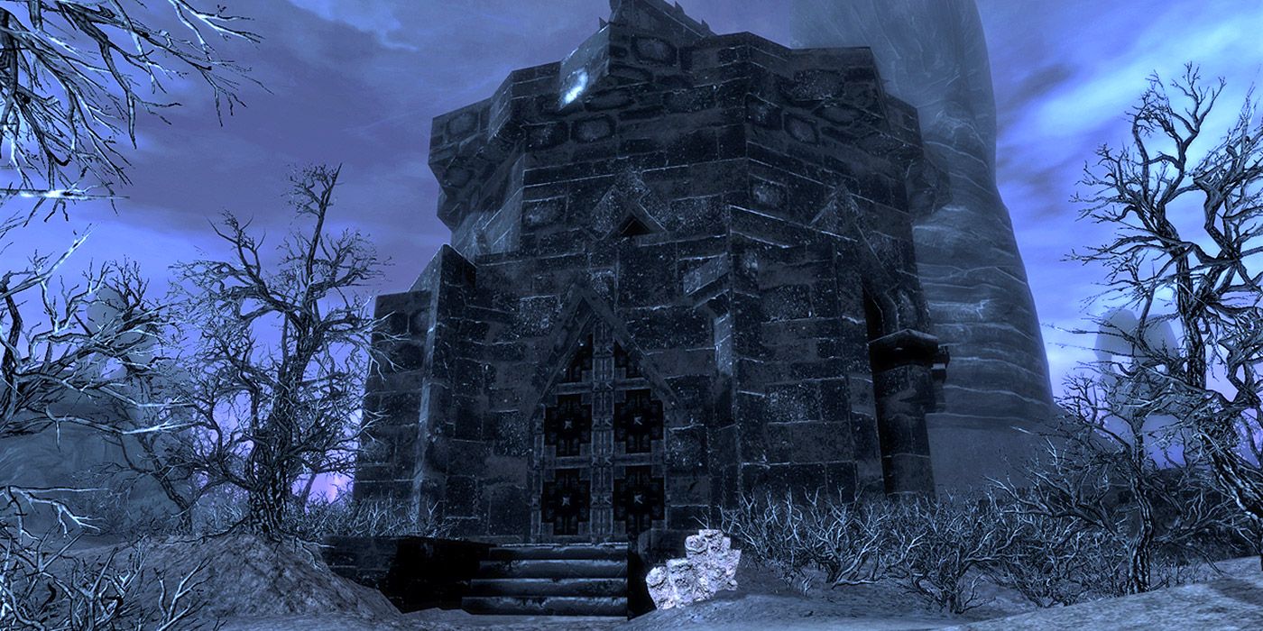 A shot of the Reaper's Lair in Skyrim, a stout, stone building with a large door.