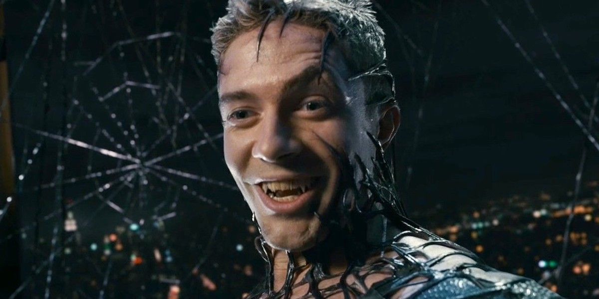 Eddie Brock as Venom smiling surrounded by dark webs in Spider-Man 3.