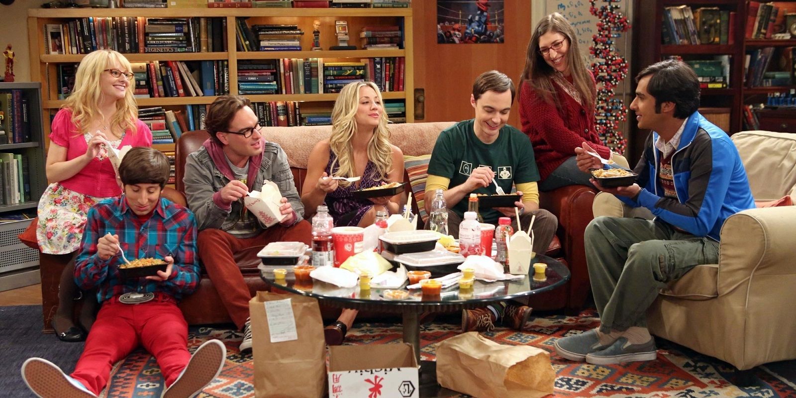 The group having dinner in the living room on The Big Bang Theory