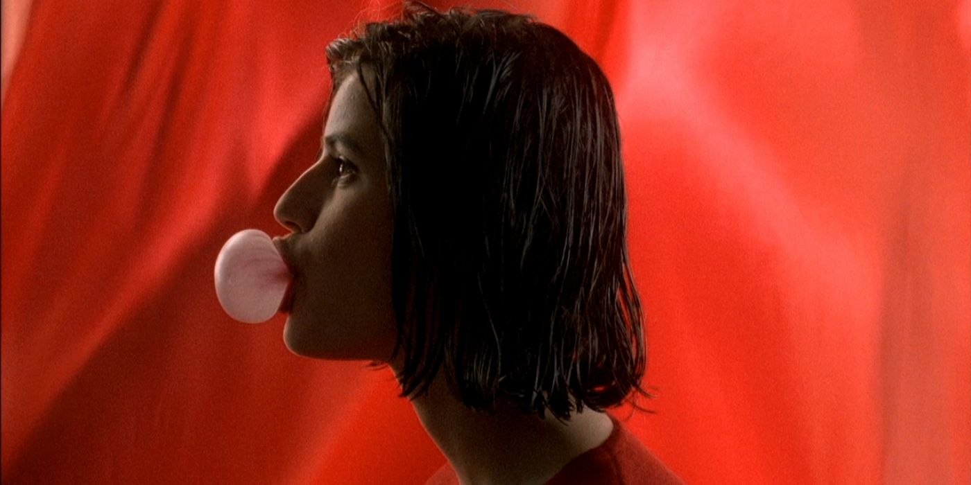 Irène Jacob as Valentine Dussaut blows a bubble in Three Colors: Red