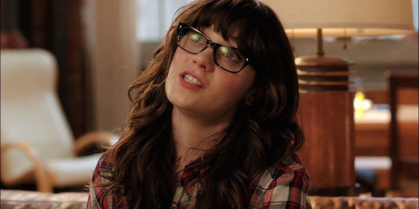 Zooey Deschanel sitting on a couch in New Girl