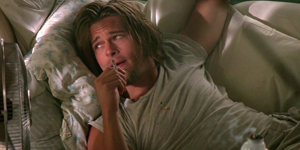 Brad Pitt laying on a couch in True Romance