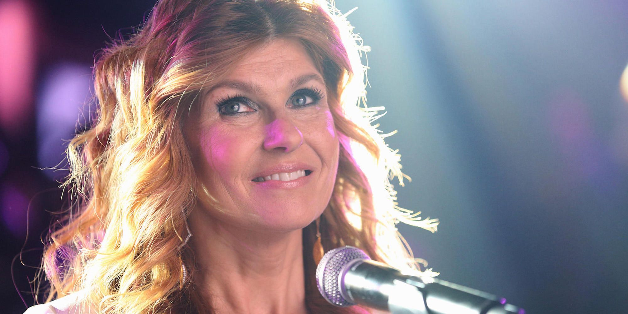 Rayna smiling as she performs on stage