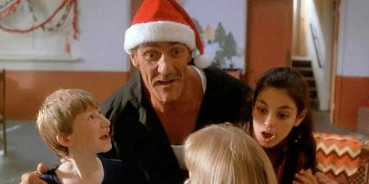Hulk Hogan and Mila Kunis in Santa With Muscles