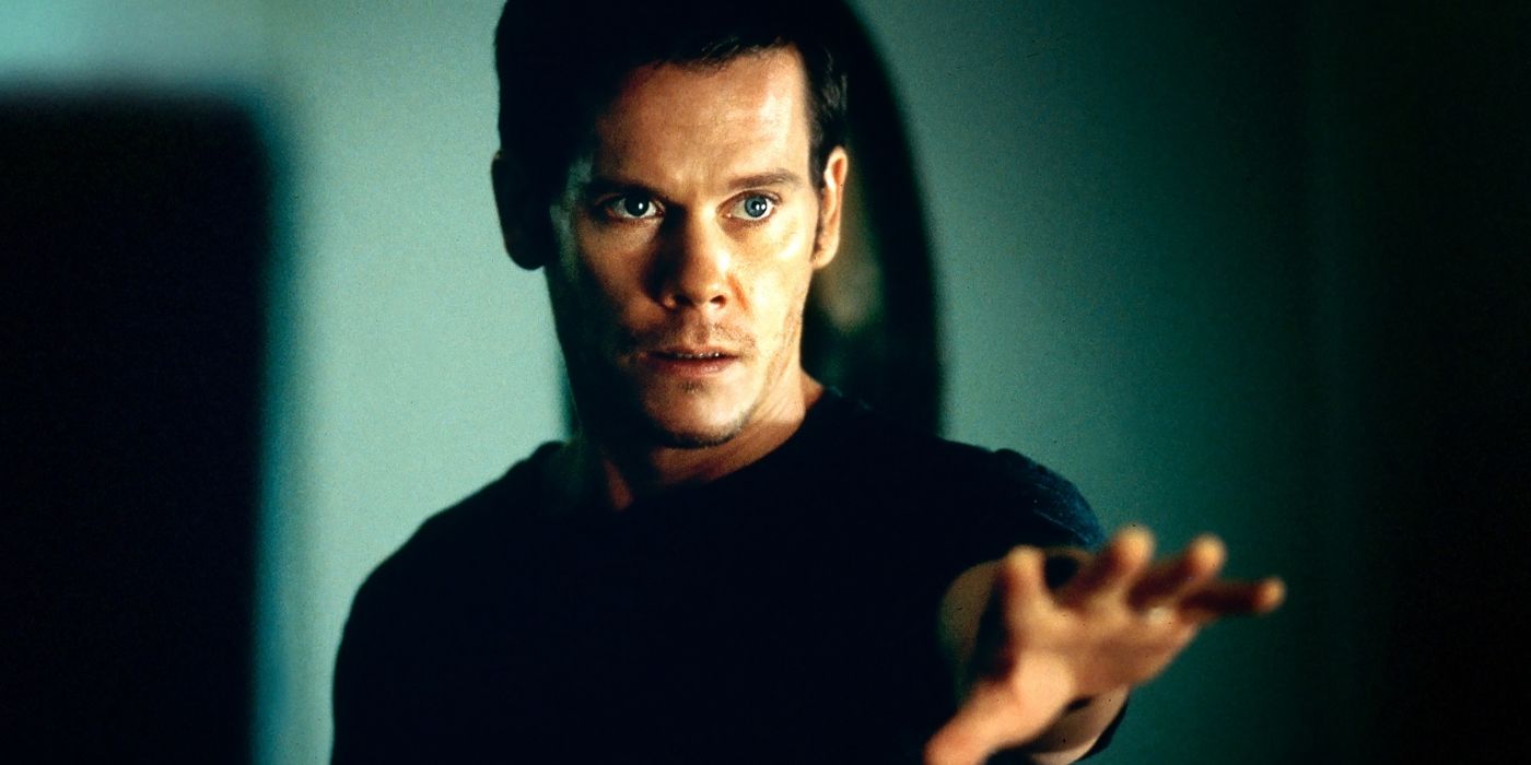 Tom reaches out to touch something in Stir of Echoes