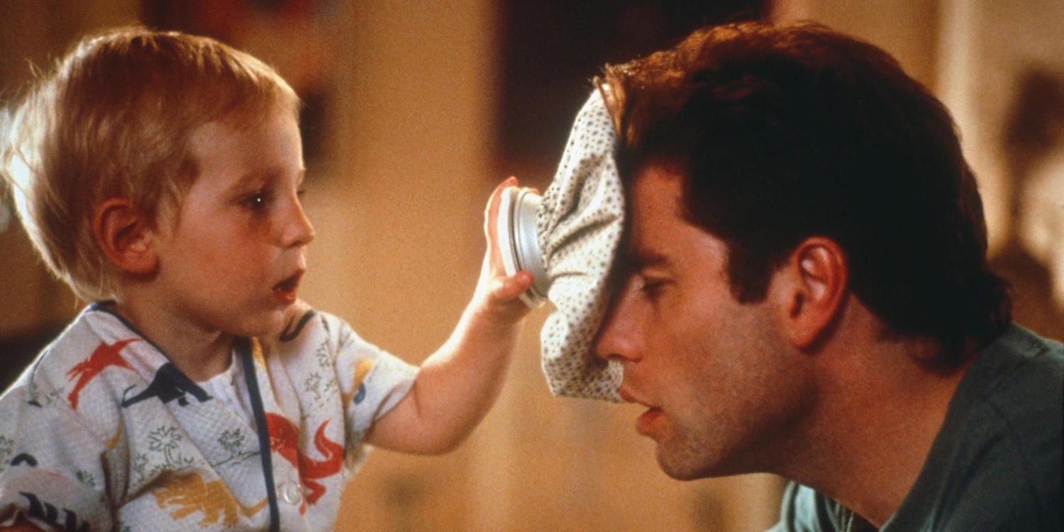 A baby putting an ice bag on John Travolta's forehead in Look Who's Talking
