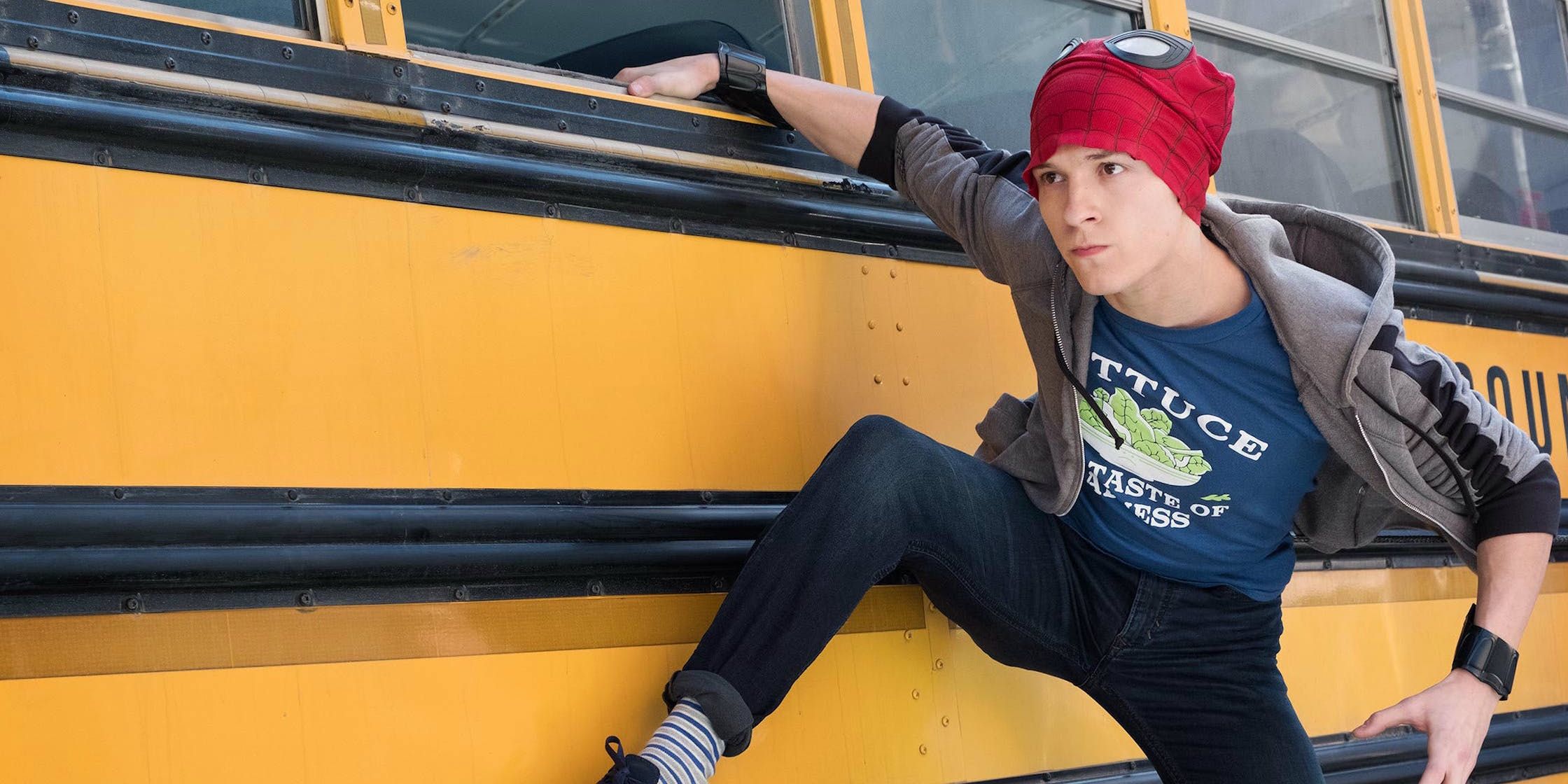 Peter Parker hangs off the edge of a bus in Marvels Spider-Man: Homecoming